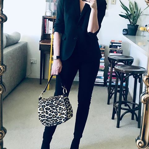 I'm wearing a black blazer black jeans and boots and carrying a leopard print bag
